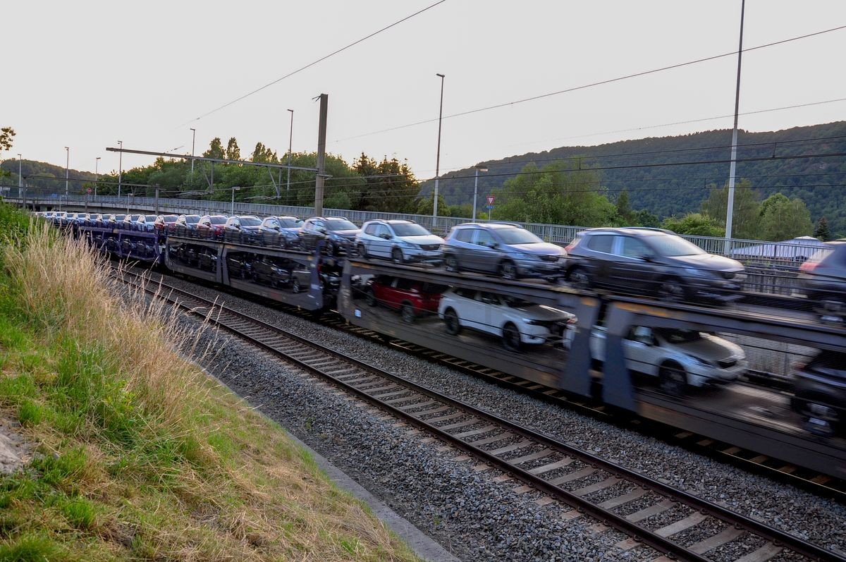 Background of transportation of cars by train between a big city in Europe on speeding motion.